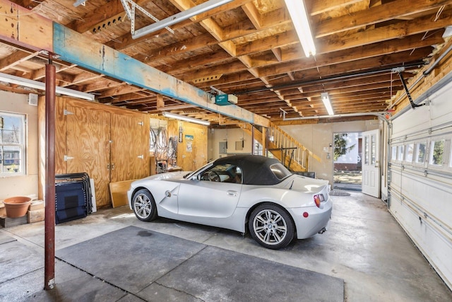 garage with electric panel and a garage door opener