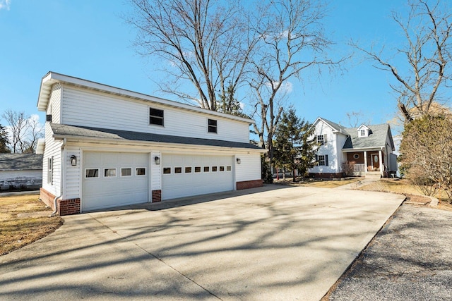 view of side of home featuring concrete driveway