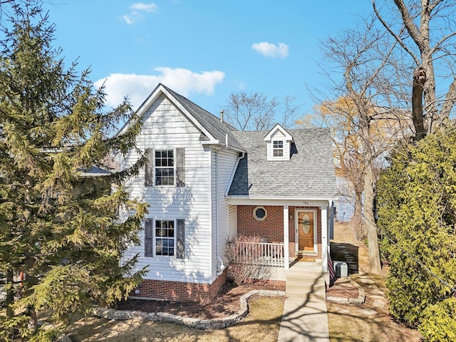 view of front of property with covered porch and roof with shingles