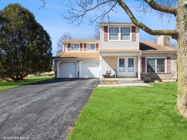 view of front facade with driveway, a garage, a chimney, and a front lawn