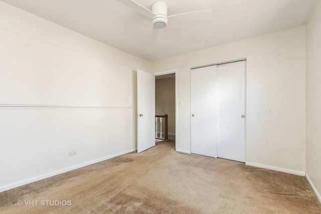 unfurnished bedroom featuring a closet, carpet flooring, ceiling fan, and baseboards