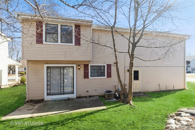 back of house with cooling unit, a lawn, and a patio