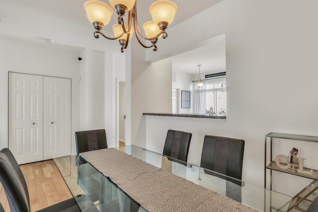 dining space featuring a chandelier and wood finished floors