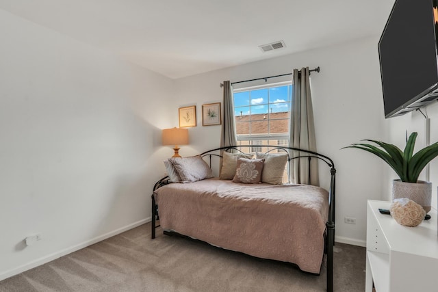 carpeted bedroom featuring visible vents and baseboards