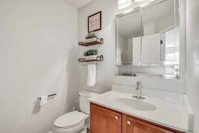 half bathroom featuring toilet and vanity