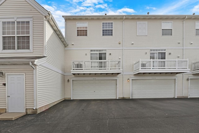 back of property featuring a garage and driveway