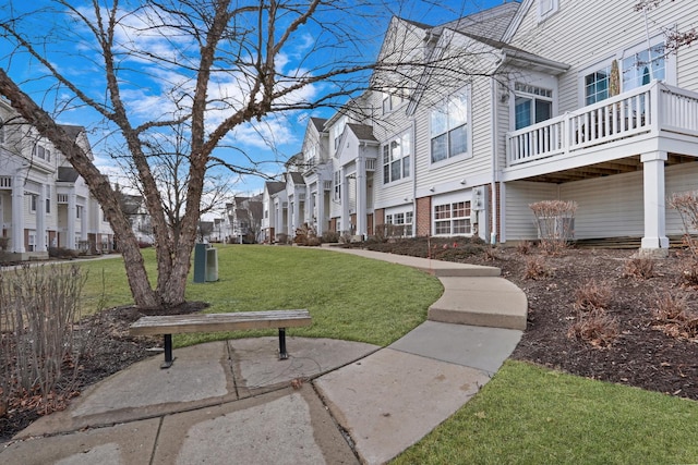 view of home's community featuring a residential view and a yard