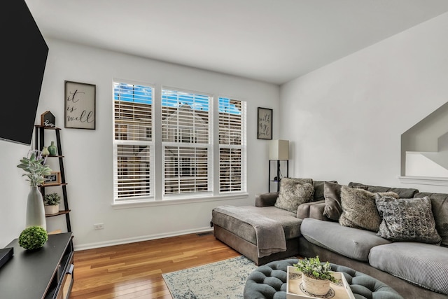 living room featuring light wood-style flooring and baseboards