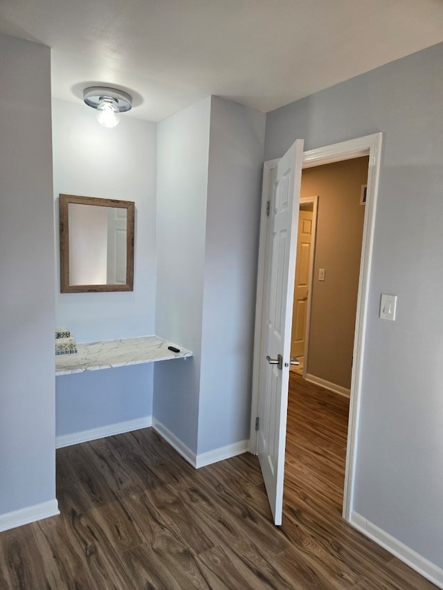 bathroom featuring wood finished floors and baseboards