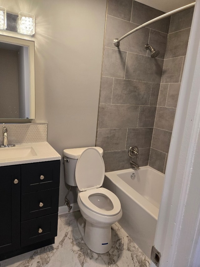 full bathroom with marble finish floor, shower / bath combination, decorative backsplash, toilet, and vanity