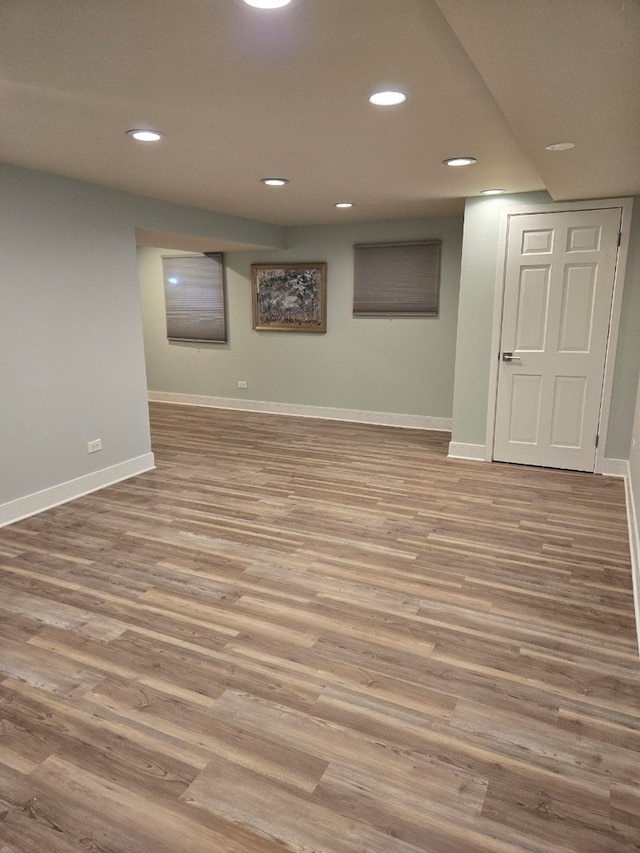 finished basement with recessed lighting, wood finished floors, and baseboards