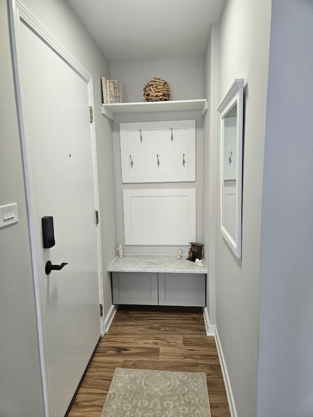 mudroom featuring dark wood-style floors and baseboards