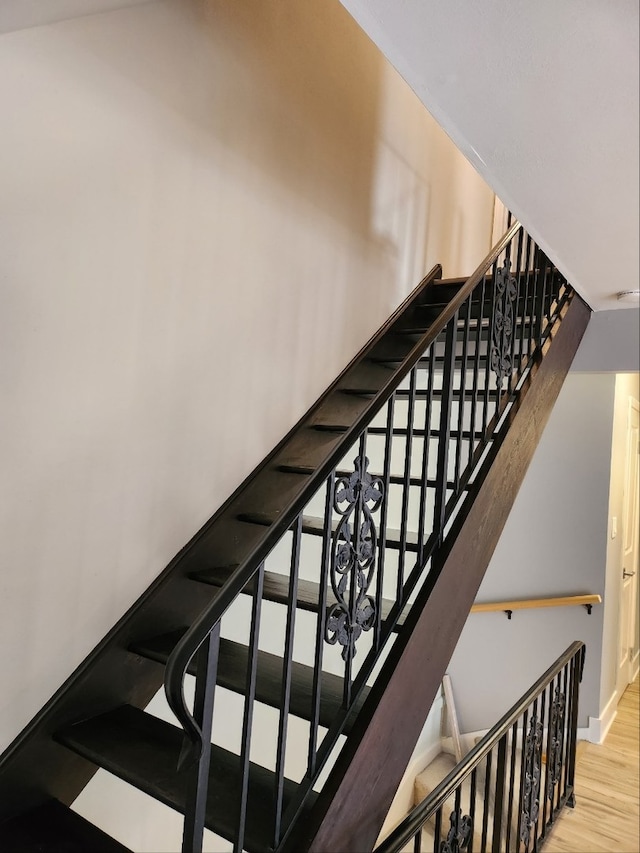 staircase with wood finished floors