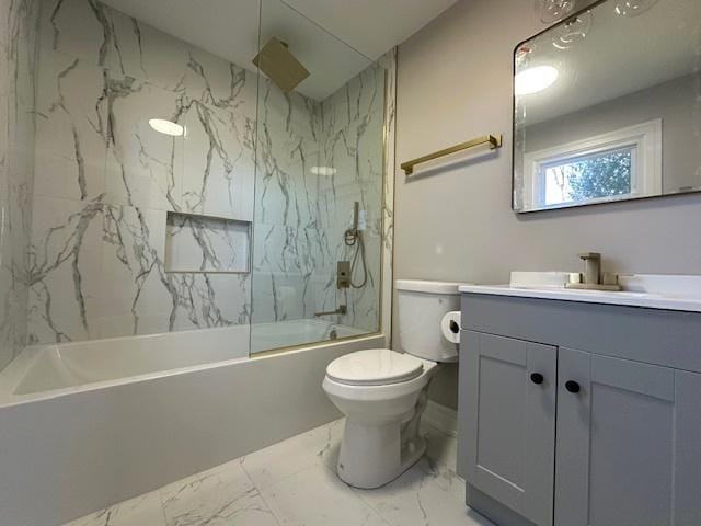 bathroom featuring toilet, marble finish floor, vanity, and a combined bath / shower with rainfall shower