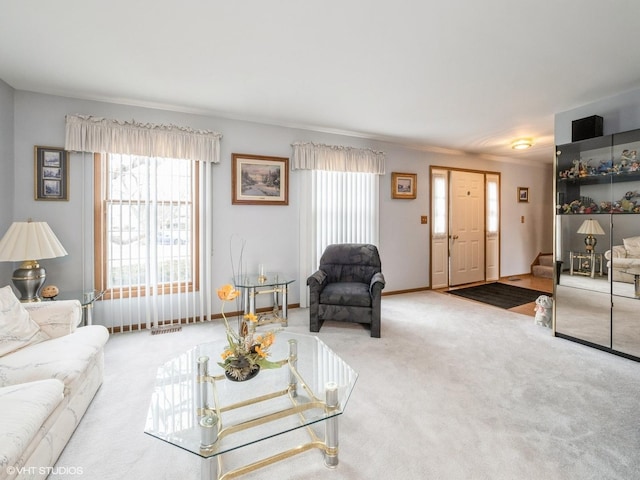 living area with carpet floors, baseboards, and stairway