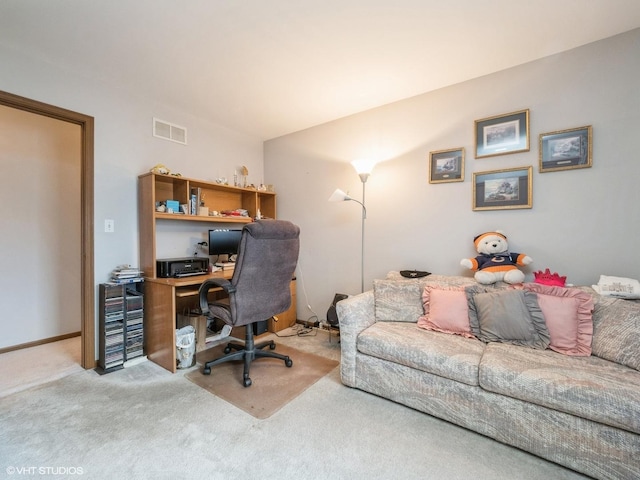 carpeted office featuring visible vents and baseboards