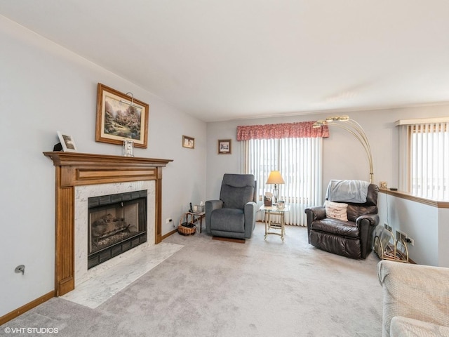 living area with carpet, a premium fireplace, and baseboards