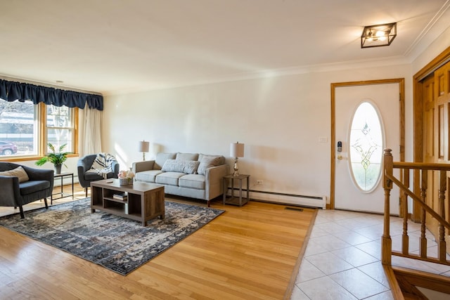 living room featuring light wood finished floors, a baseboard heating unit, and ornamental molding