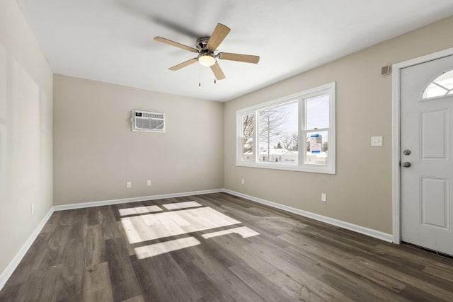 foyer with ceiling fan, baseboards, dark wood-style flooring, and a wall mounted AC