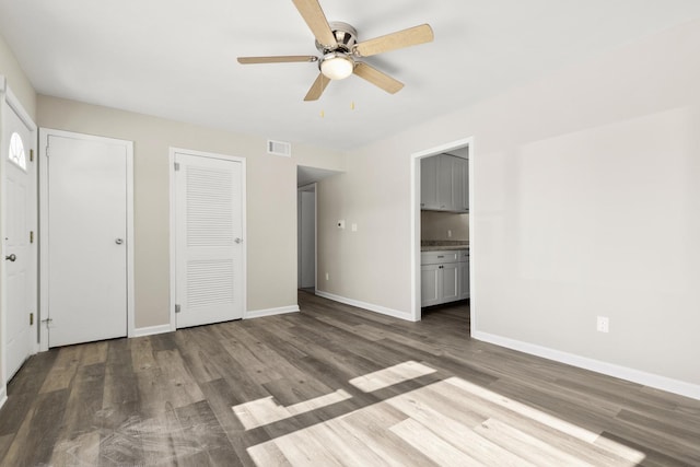 unfurnished bedroom with wood finished floors and baseboards