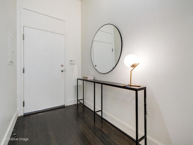 foyer with dark wood-style floors and baseboards