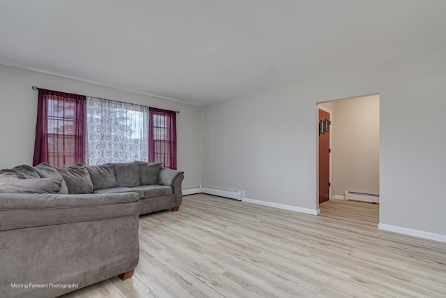 living area with light wood finished floors, a baseboard radiator, baseboards, and baseboard heating