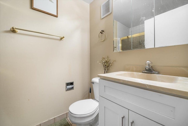 bathroom featuring visible vents, toilet, and vanity