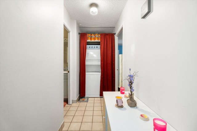 hallway featuring light tile patterned floors and a textured ceiling