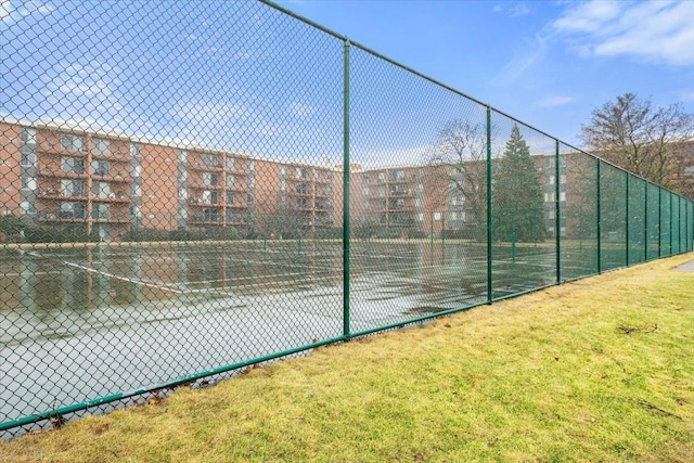 view of tennis court with fence