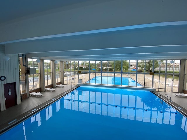 pool with a lanai and a patio area