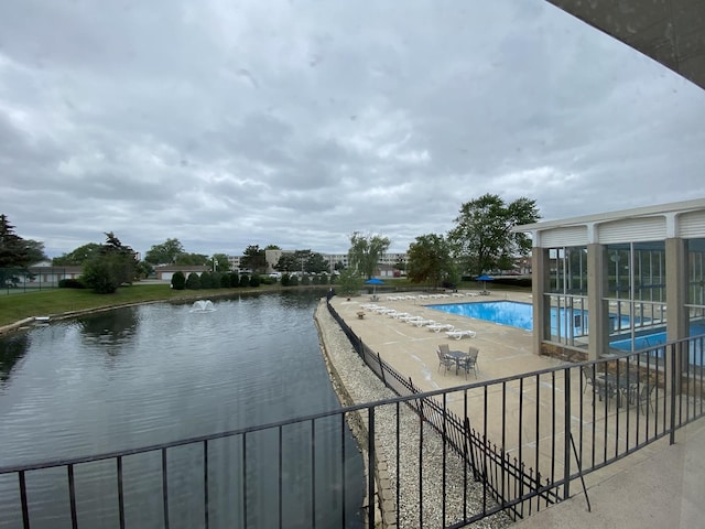 community pool with a patio and fence