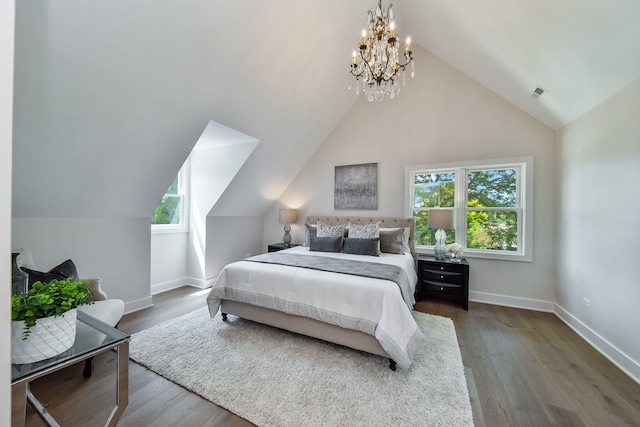 bedroom with lofted ceiling, baseboards, and wood finished floors