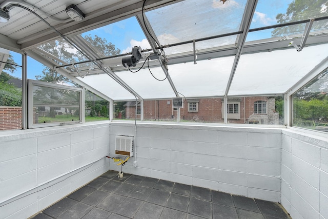 unfurnished sunroom featuring lofted ceiling and a healthy amount of sunlight