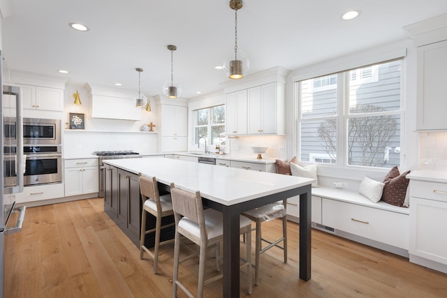 kitchen with light countertops, appliances with stainless steel finishes, and white cabinetry