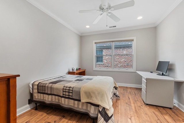 bedroom featuring ceiling fan, visible vents, baseboards, light wood-type flooring, and crown molding