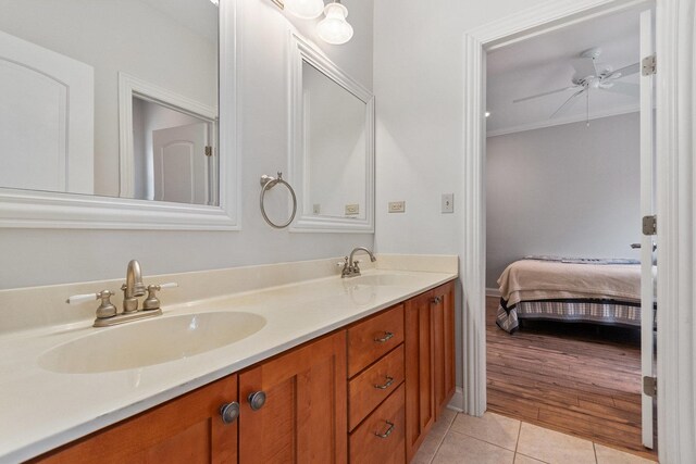 full bathroom with ensuite bathroom, double vanity, a sink, and tile patterned floors