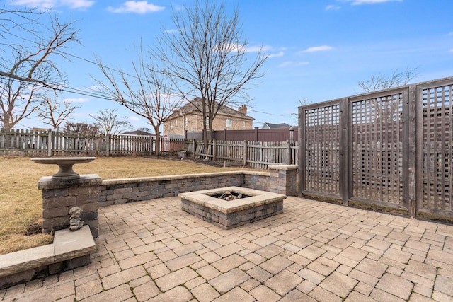view of patio / terrace featuring an outdoor fire pit and a fenced backyard