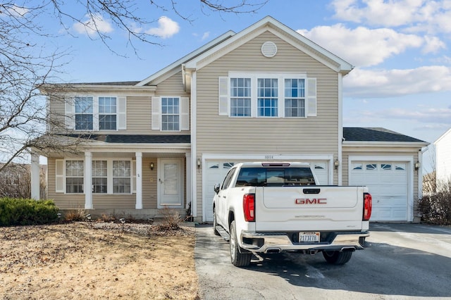 traditional home with aphalt driveway and a garage