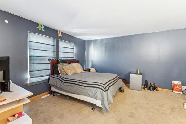 bedroom with carpet flooring and baseboards