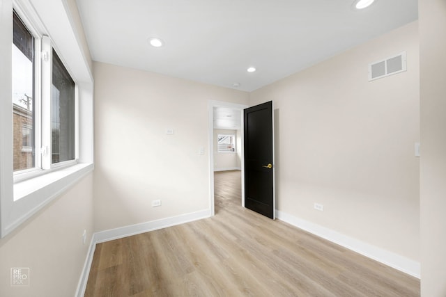 spare room featuring recessed lighting, visible vents, light wood-style flooring, and baseboards