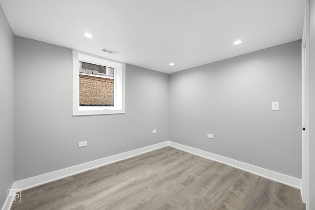 empty room with visible vents, baseboards, and wood finished floors