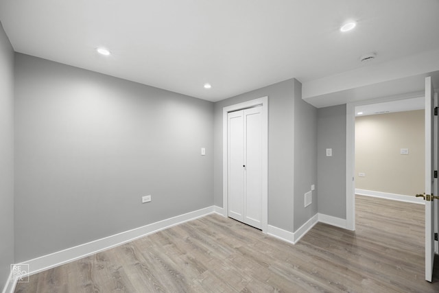 interior space with recessed lighting, wood finished floors, and baseboards