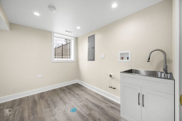 washroom featuring laundry area, washer hookup, a sink, baseboards, and electric panel