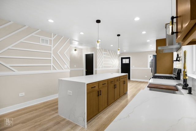 kitchen with recessed lighting, visible vents, light wood-type flooring, a center island, and decorative light fixtures