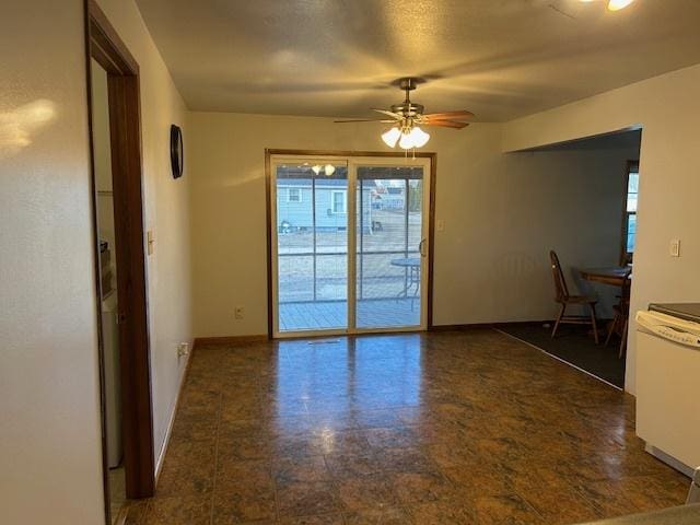 interior space featuring ceiling fan and baseboards