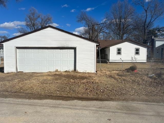 detached garage featuring fence