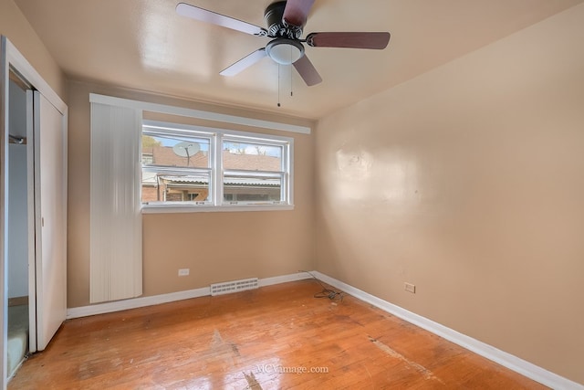 unfurnished room featuring baseboards, ceiling fan, visible vents, and light wood-style floors