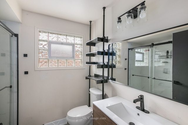 full bathroom with a stall shower, vanity, and toilet