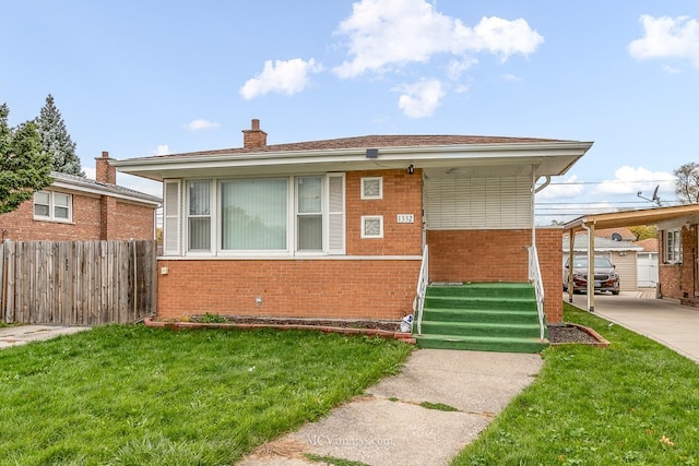 bungalow-style home with entry steps, brick siding, a chimney, fence, and a front yard