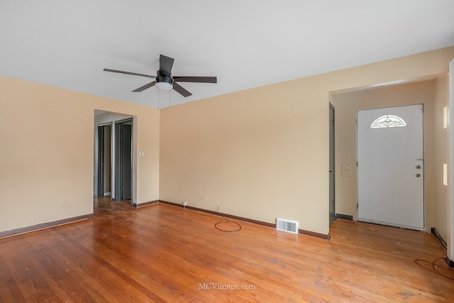 interior space with visible vents, baseboards, and wood finished floors